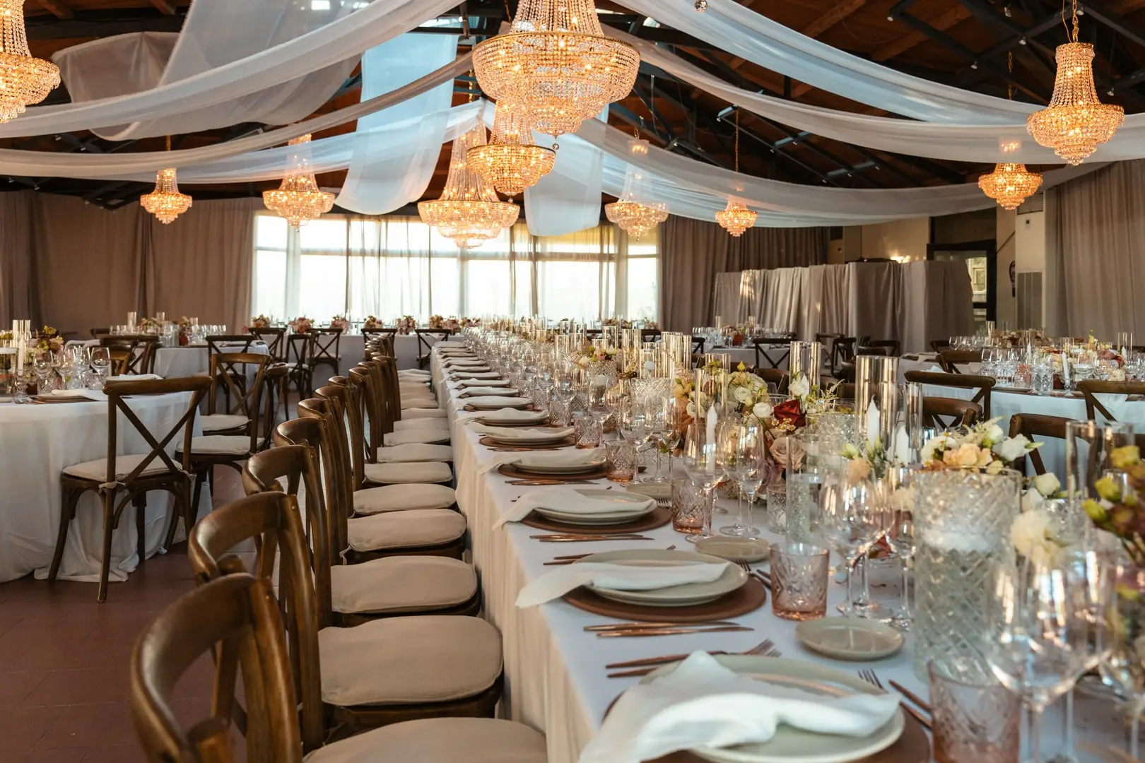 The glazed hall with long tables and crystal chandeliers